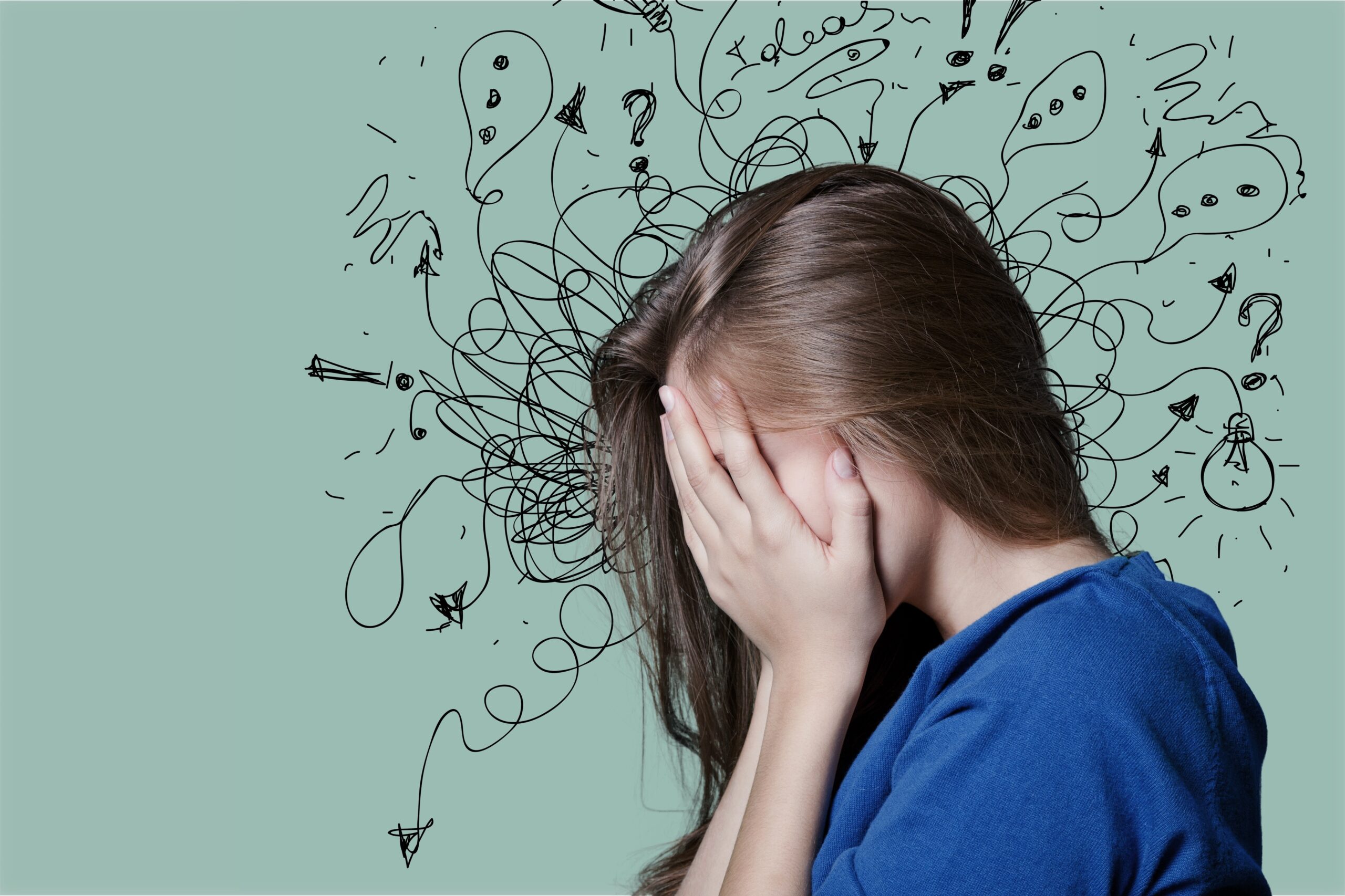 A person with long brown hair wearing a blue shirt covers their face with both hands. Behind them, there is a chaotic mix of black doodles, including squiggly lines, question marks, exclamation points, and light bulbs, representing confusion or stress.